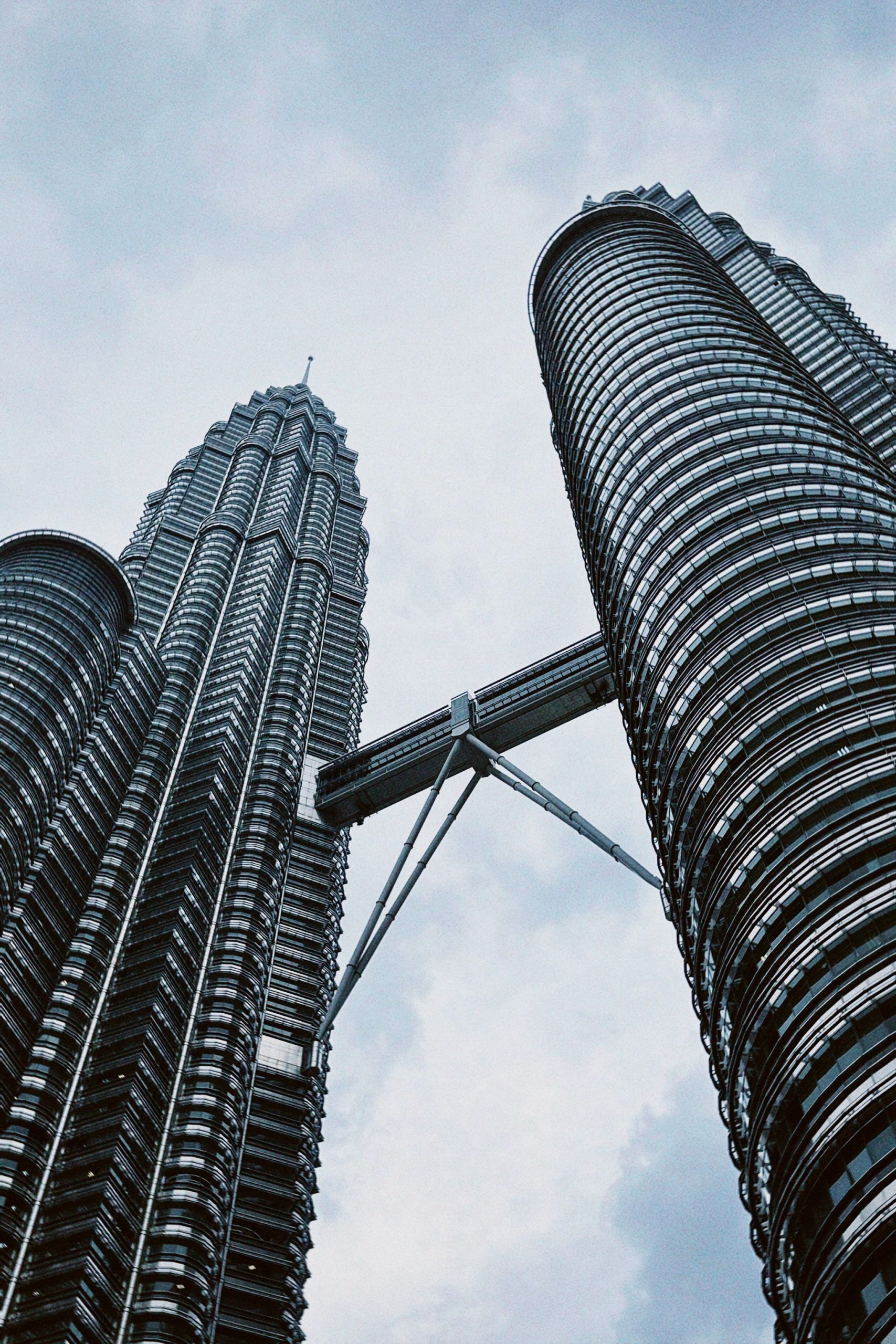 Low-angle shot of the iconic Petronas Twin Towers in Kuala Lumpur, showcasing modern architecture.