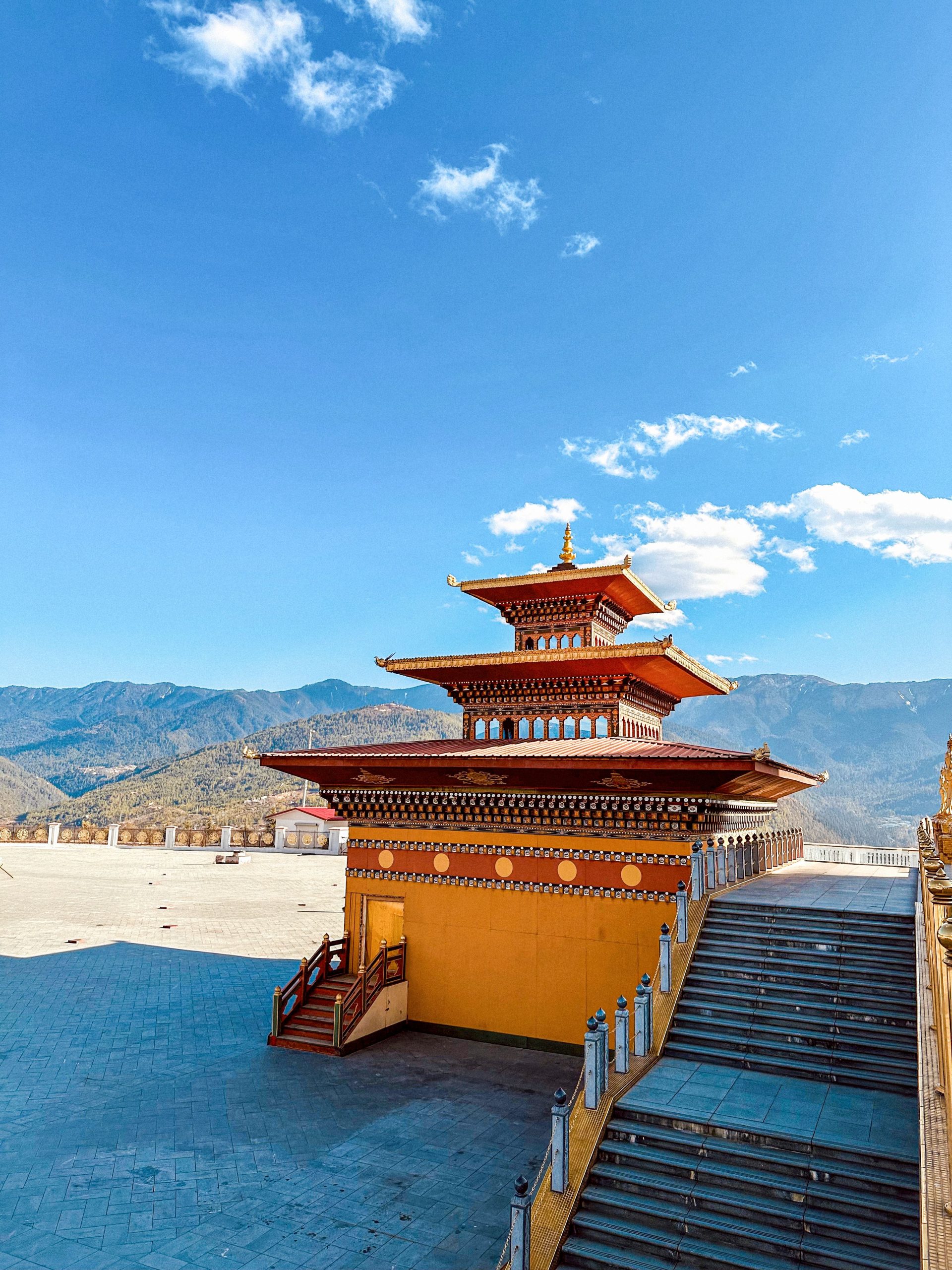 Explore the serene beauty of a Bhutanese temple against the stunning Himalayan backdrop.